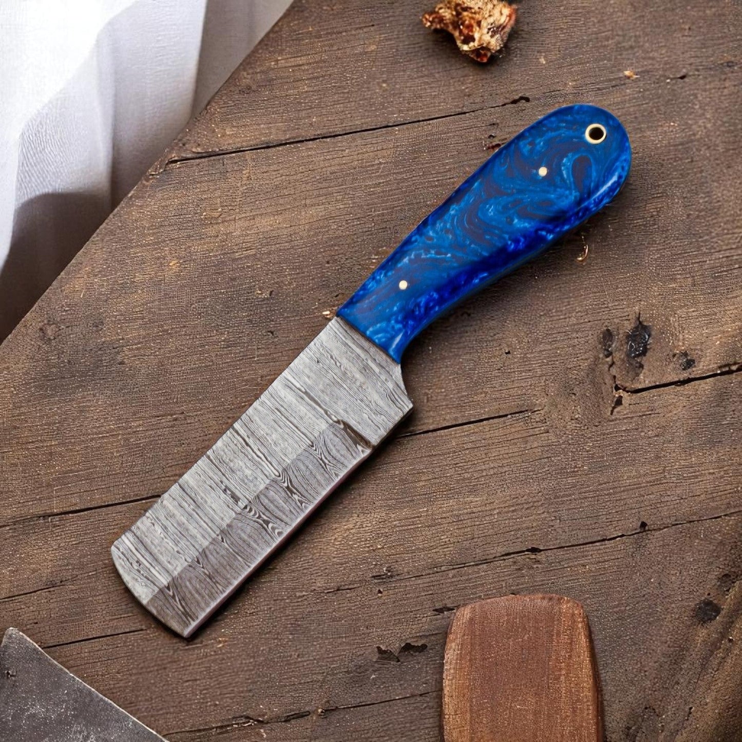 Knife with a blue handle on a wooden surface